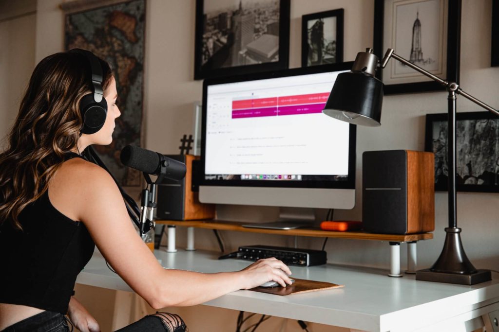 Woman listening to headphones using computer