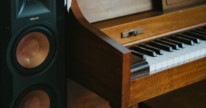 Black Klipsch Speaker and Piano