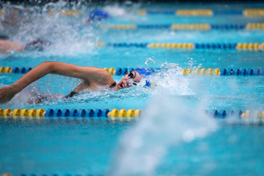 A Woman Swimming With Waterproof Earbuds