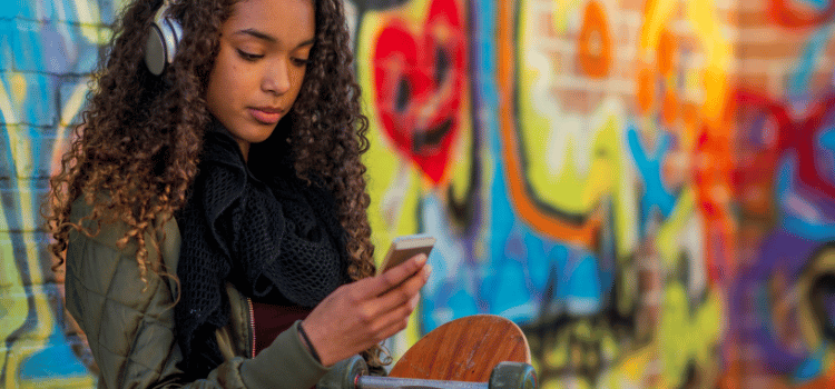 girl with skateboard listening to headphones